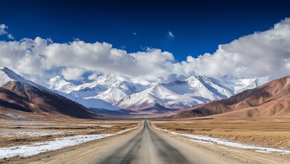 Driving on a Desert Road Towards Snow Capped Mountains and Cloudy Sky