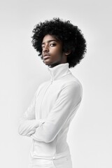 Obraz premium Stylish African American Man in Minimalist Studio Portrait with Afro Hairstyle