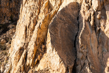 Sunlit rock formation with dramatic shadows in mountain landscape