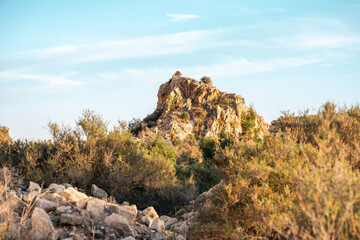 Scenic rocky terrain under clear blue skies and sunlight