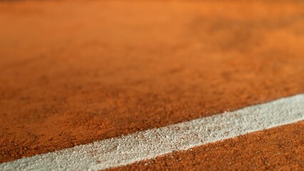 Freeze Motion Detail Shot of Tennis Ball Hitting a Clay Court
