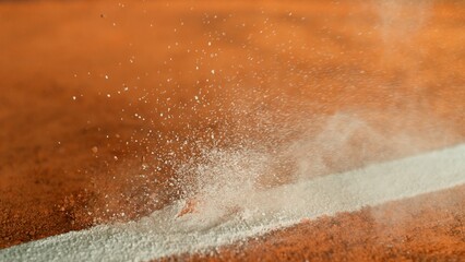 Freeze Motion Detail Shot of Tennis Ball Hitting a Clay Court