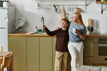 Mother shares a moment of joy with her son in their bright modern kitchen