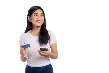 Happy young Asian woman holding smartphone and credit card, smiling and looking up, isolated on transparent background