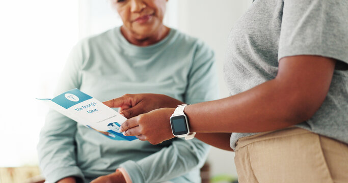 Clinic, patient and caregiver with brochure for consultation, diagnosis information or healthcare service. Hands, medical consultant or senior woman with pamphlet for advice, recovery tips or support