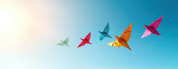 colorful origami birds soaring in blue sky, Colorful origami birds soaring in blue sky for creative backgrounds with colorful origami birds in motion and paper-themed design of colorful origami birds 