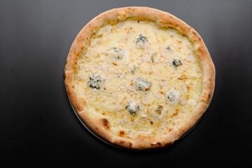 Delicious White Pizza Topped with Almonds and Blue Cheese on a Dark Surface