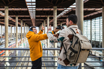 Tourists taking photos and videos at the train station