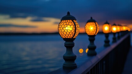 Fototapeta premium A row of lit lamps alongside a body of water at dusk