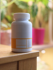 A Minimalist White Supplement Bottle Featuring a Distinctive Orange Label Design