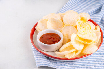Crispy airy rice shrimp chips. Fragrant prawn crackers with sauce, traditional Asian fast food snack, junk food healthier alternative