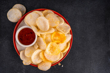 Crispy airy rice shrimp chips. Fragrant prawn crackers with sauce, traditional Asian fast food snack, junk food healthier alternative