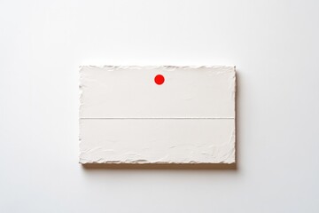 Minimalist design featuring textured paper with striking red dot
