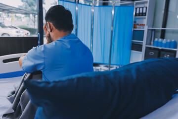 Lonely man silhouette sitting on the bed feeling depressed and stressed in the dark bedroom, Depression and anxiety disorder concept