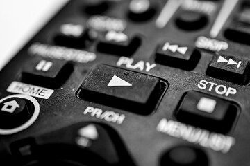 play button on a dirty and dusty tv remote control unit