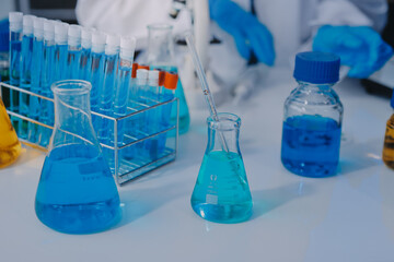 Chemists in a lab developing cosmetic products, testing and analyzing formulas for quality and effectiveness.