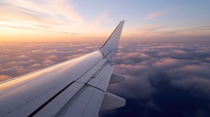 Wing of airplane gliding above fluffy clouds during vibrant suns