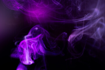 Purple and black swirling smoke creates an ethereal, mystical atmosphere. The wisps of smoke form delicate, fluid patterns against a dark background, adding a sense of mystery and intrigue.