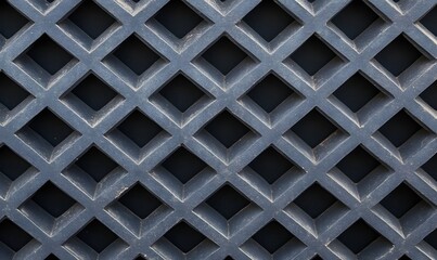 A close up of a dark gray lattice pattern forming diamond shapes with deep shadows in the background