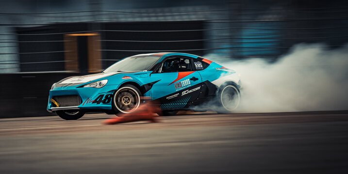 A blue and orange car with a lot of smoke coming out of it