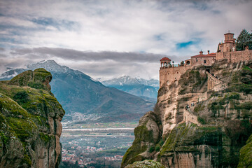 Naklejka premium Meteora is a rock formation with a complex of Orthodox monasteries perched on its peaks. And a long staircase leading to the monastery runs along the slopes of this mountain. 