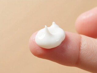 Moisturizing cream application on fingertip