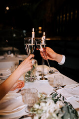 Toasting during a romantic dinner celebration at an elegant restaurant in the evening