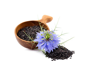 Black cumin  on white background closeup. Cumin seeds with flower.