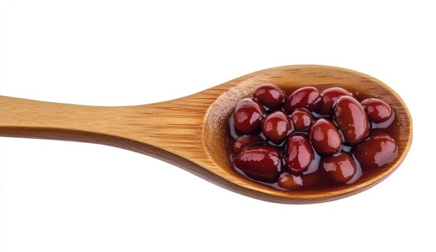 Wooden spoon filled with red beans in a sauce