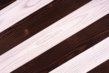 Alternating dark brown and white wooden planks with natural wood grain texture, rustic background for design and print