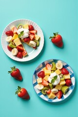 Delicious fruit salad with strawberries, kiwi, banana and pineapple, topped with cream. Perfect summer dessert.
