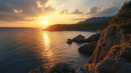 Fototapeta premium Idyllic sunset view over rocky Mediterranean coastline in warm golden light