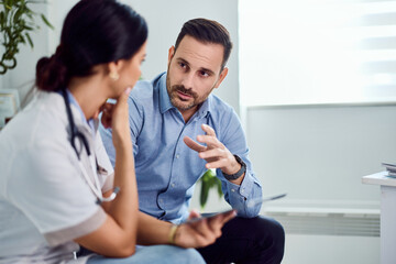 Doctor Discussing Health Concerns With Patient in a Modern Medical Office Setting