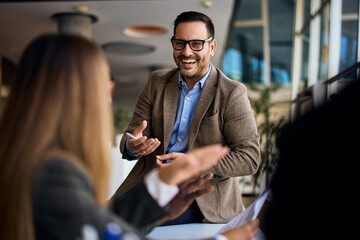 Professional Businessman Engaging With Colleagues During an Office Meeting