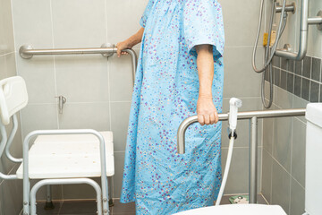 Asian elderly woman patient use toilet bathroom handle security in nursing hospital, healthy strong...
