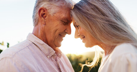 Senior couple, care and forehead touch for love, strong connection and healthy relationship. Romance, happy man and woman outdoor for bonding together, loyalty or commitment to marriage in retirement