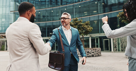 Business people, outdoor and handshake with greeting, hello and agreement for project. Employees,...