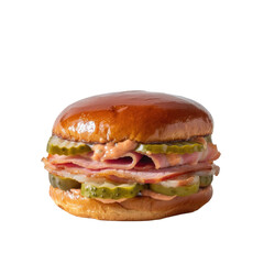 Delicious gourmet sandwich with ham, pickles, and creamy sauce on a shiny brioche bun