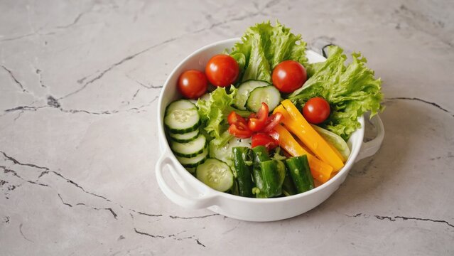 A white bowl filled with various colorful vegetables