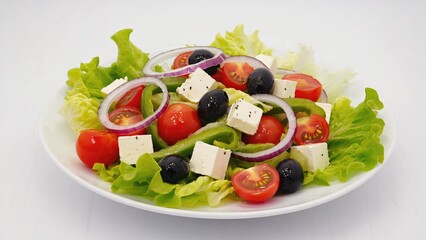 A healthy salad served on a clean white plate, perfect for lunch or dinner