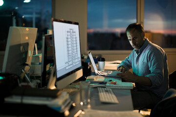 Man working overtime in an office designing
