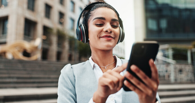 Business woman, headphones and smartphone in city with commute, music and streaming sound on web. Person, phone and travel in town with audio, subscription and search for song on trip in Colombia