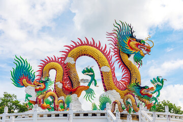 Fototapeta premium Beautiful giant or big colorful dragon statue with blue sky at Nakornsawan Park, Thailand.