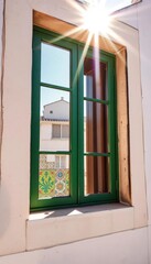 Obraz premium Sunlit Lisbon window with vibrant azulejo tiles, traditional, architecture