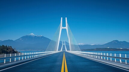 Fototapeta premium Long, white suspension bridge crossing water with mountain backdrop