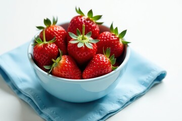 Fresh strawberries in a bowl, blue napkin, white background, table, macro, bright