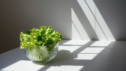 Fresh lettuce in a glass bowl on a table, perfect for salads or as a centerpiece