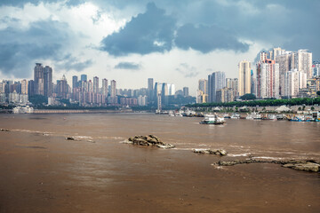 Panoramic view of Chongqing cityscape with Yangtze River and dramatic sky. Travel and tourism background.