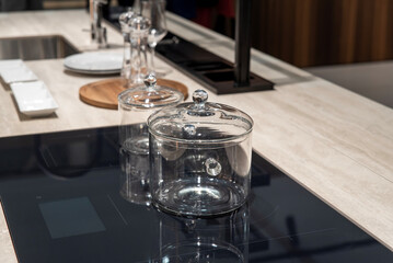 Glass pots with lids on a modern induction hob