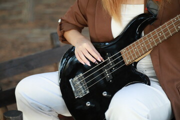 Girl Plays The Bass Instrument In The Countryside In Summer